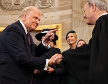 Donald Trump shaking hands with John Roberts