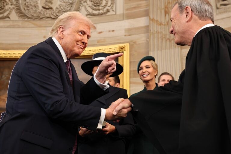 Donald Trump shaking hands with John Roberts