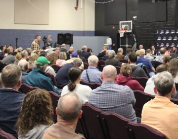 attendees and officials at a public meeting