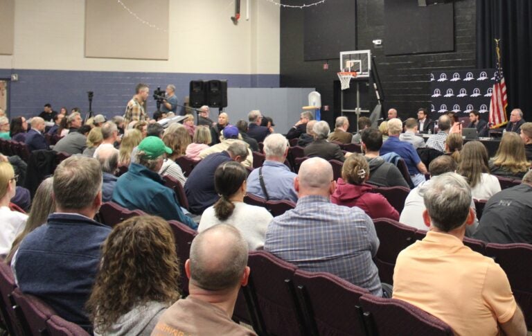 attendees and officials at a public meeting