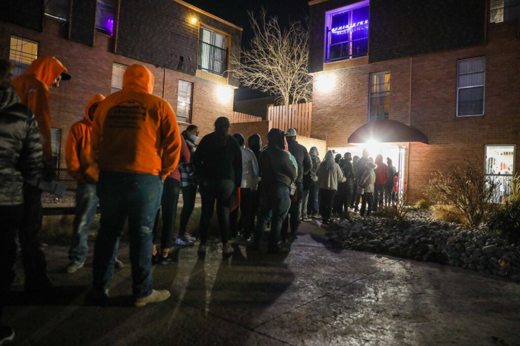 People waiting in line to get into a building