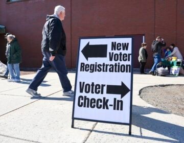 A sign at a polling place indicating where to vote and where to register