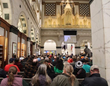 A large crowd is gathered to listen to an organ concert in Philadelphia