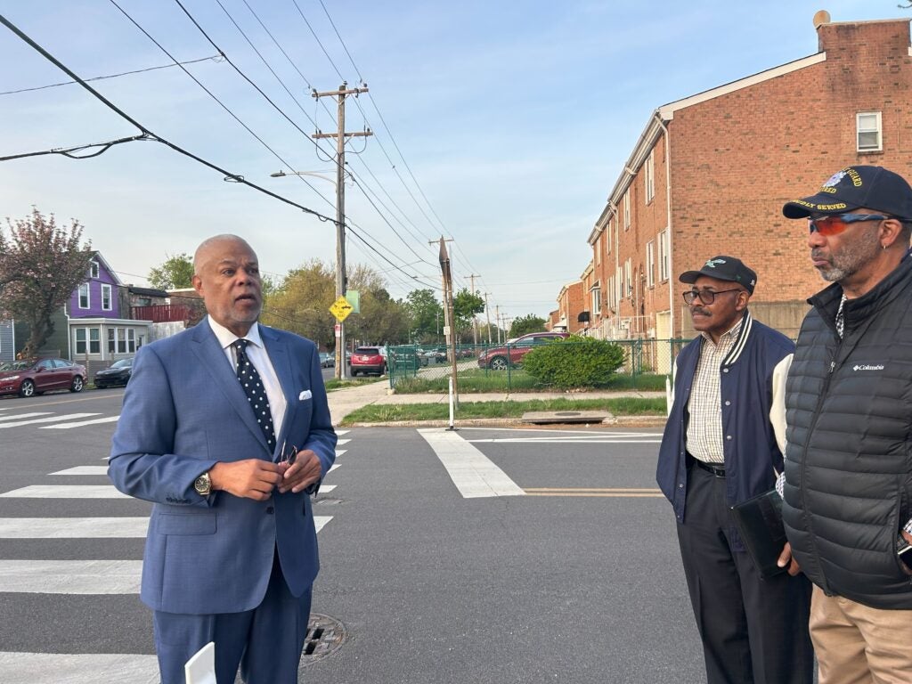 Pennsylvania state Sen. Anthony H. Williams (left) speaks with Eastwick residents