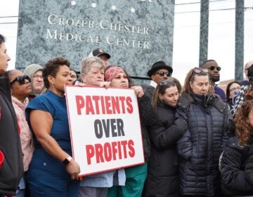 Crozer Health staff protesting with a sign reading PATIENTS OVER PROFITS