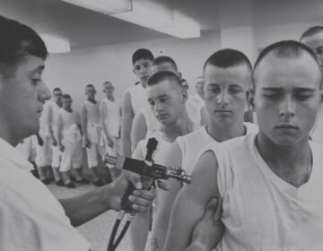 Navy recruits in 1965 wait in line for immunizations