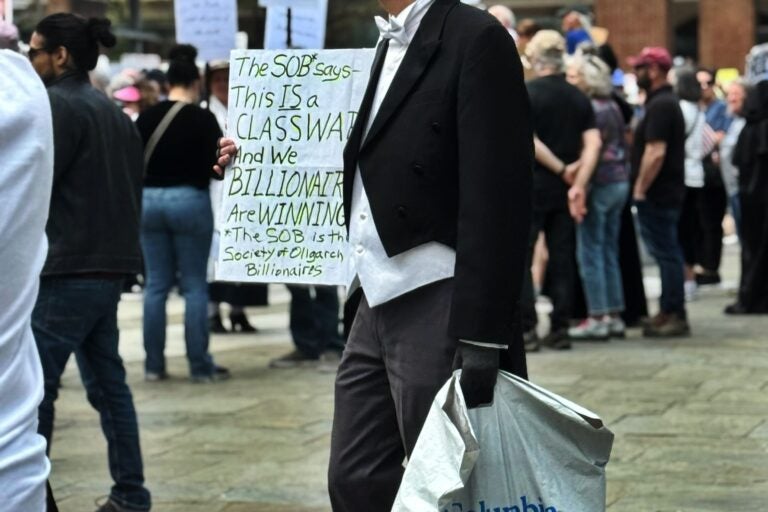 A man in a top hat participates in a protest against the Trump administration in Philadelphia