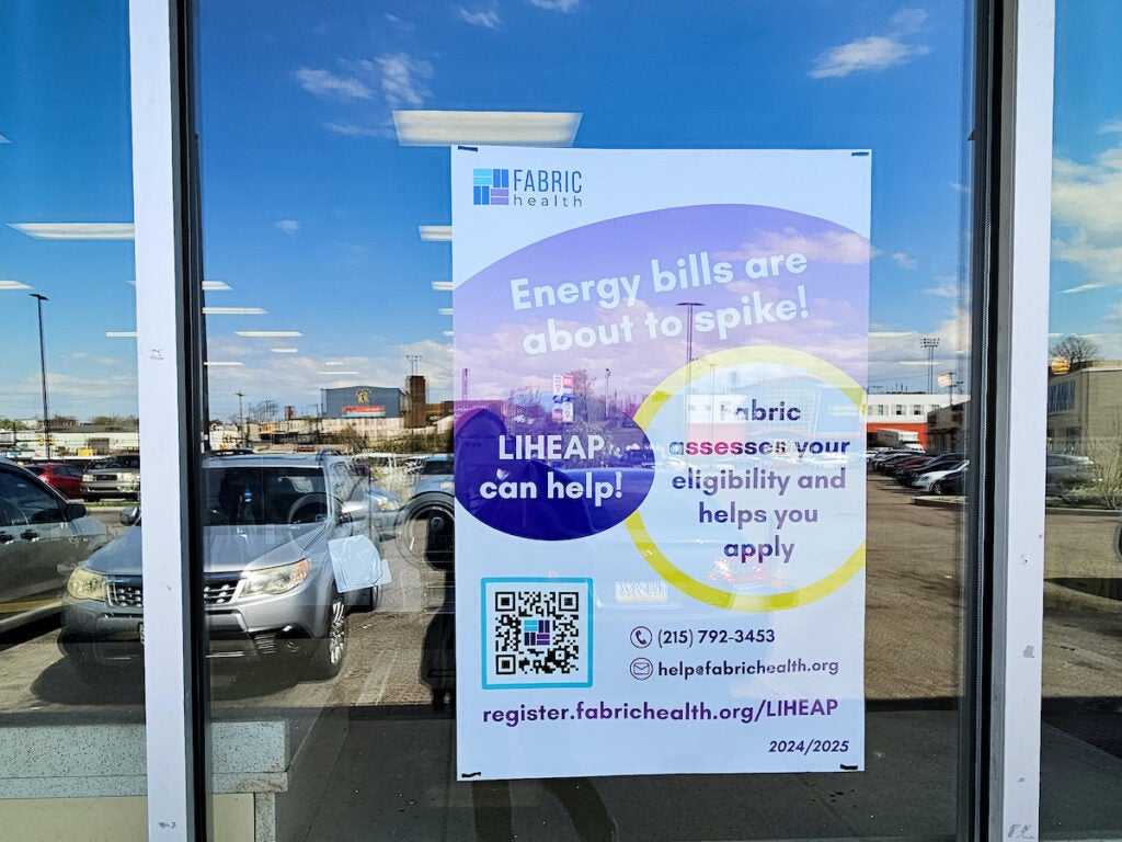 Fabric Health poster with scan code in laundromat window