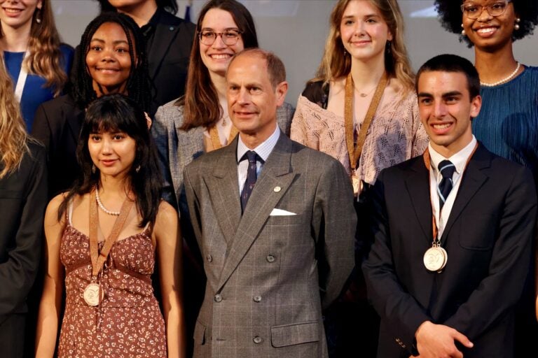 Prince Edward poses with recipients of the Duke of Edinburgh International Awards