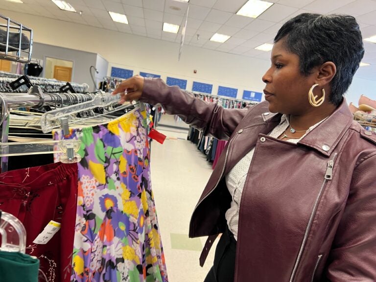 thirft-store-tarrif-silver-lining-ZR-041825-O5 Woman observing clothing rack at B-Bop Vintage in Philadelphia