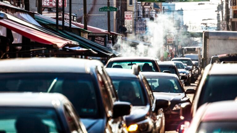 Philadelphia traffic – 9th Street Italian Market. Cars sitting in traffic on a busy street
