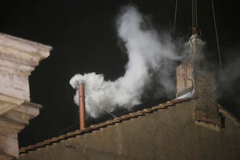 white smoke coming out of a chimney at night
