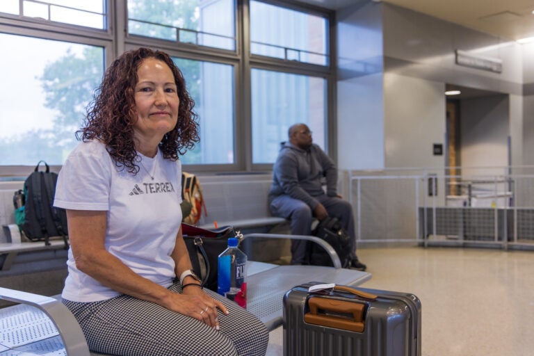 Mary Ann Howard sits in an NJ Transit station