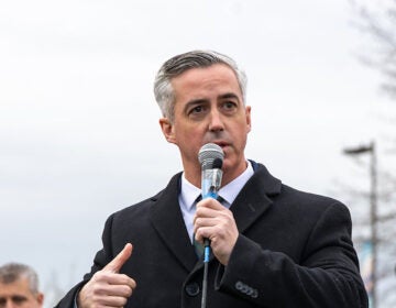 Bob Harvie speaking into a microphone at a press conference