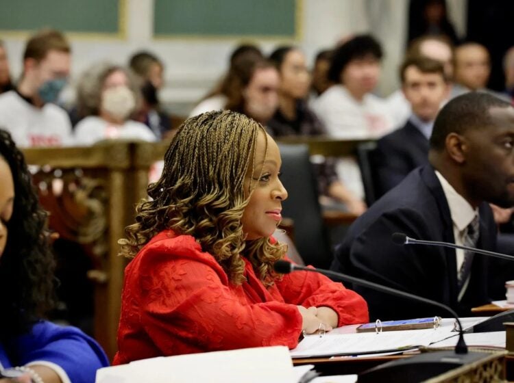 Jamie Gauthier sits in front of a microphone