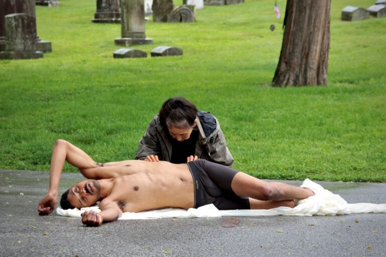 Eiko Otake touches the torso of DonChristian Jones in a performance at Laurel Hill Cemetery for the Death and Arts Festival