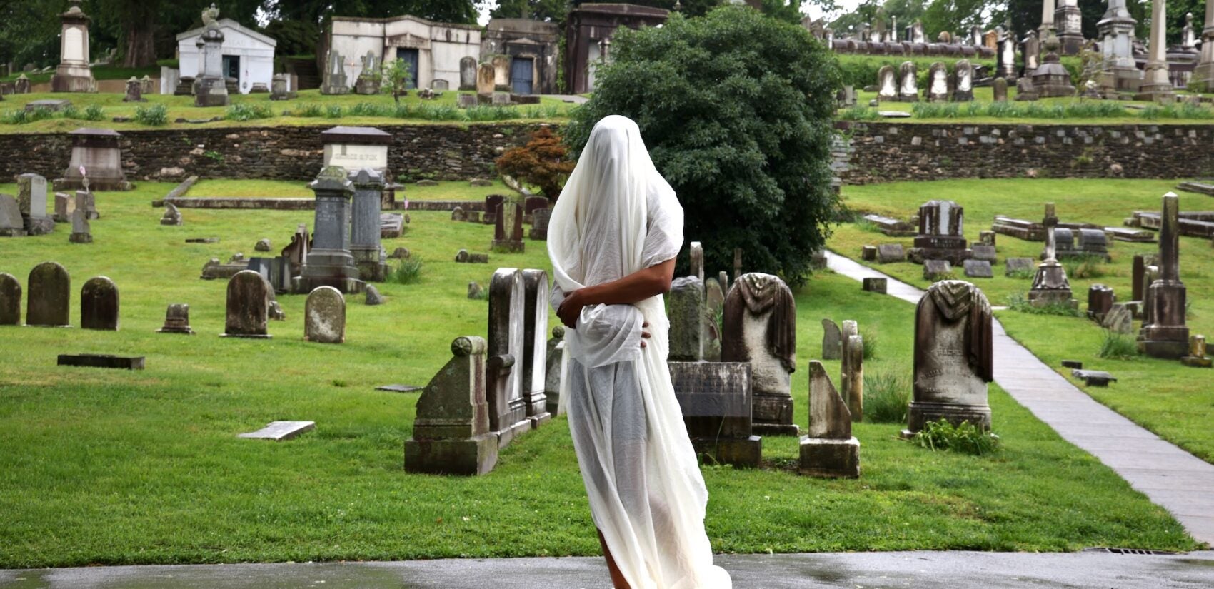 2025 05 28-e lee-donchristian jones-philadelphia laurel hill cemetery-politics of mourning iv shroud DonChristian Jones with a sheet over his body for a performance at Laurel Hill Cemetery for the Death and Arts Festival