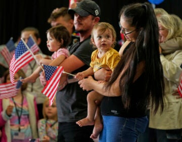 Afrikaner refugees from South Africa holding American flags