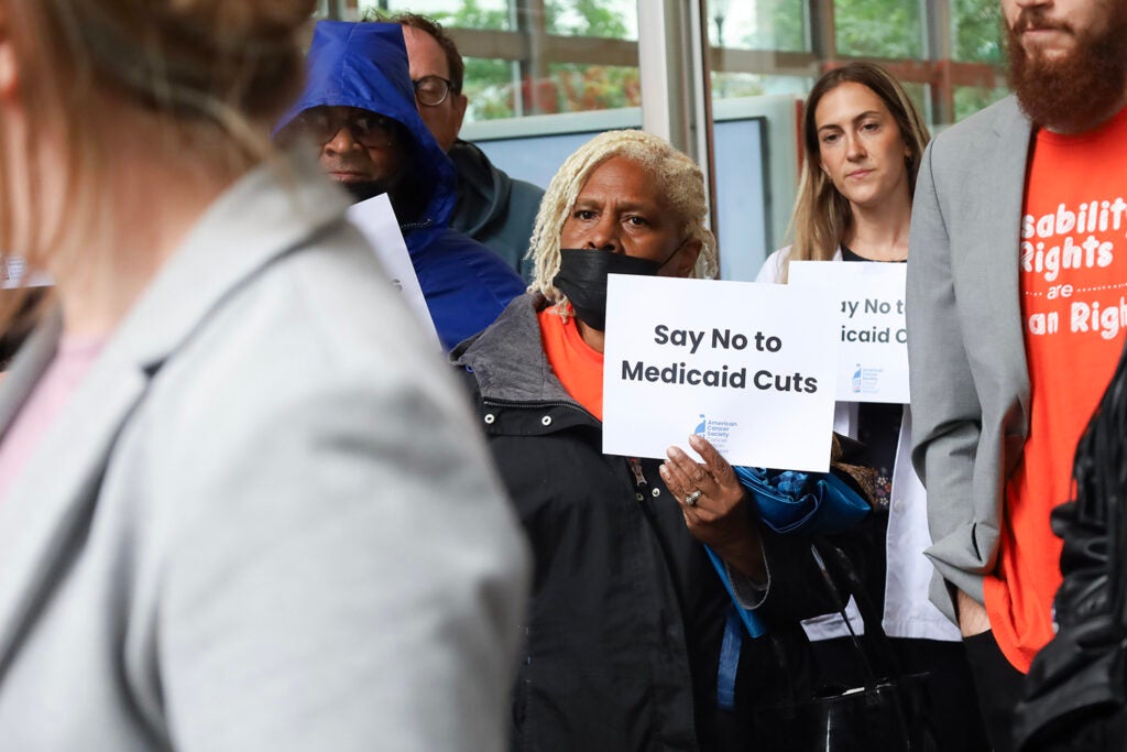 A woman holds a sign that says "say no to Medicaid cuts" at a rally in Philadelphia