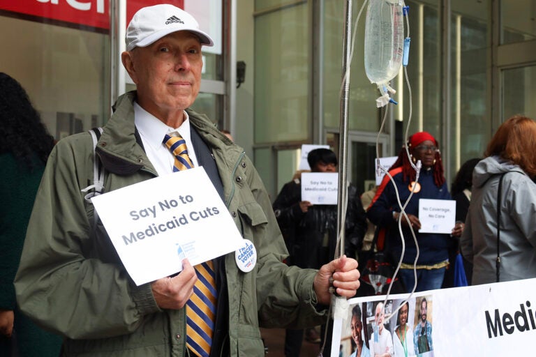 A man holds a sign that says 
