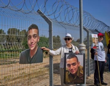 Varda Ben Baruch holds a picture of her grandson Edan Alexander near the Gaza border in Kibbutz Nir Oz
