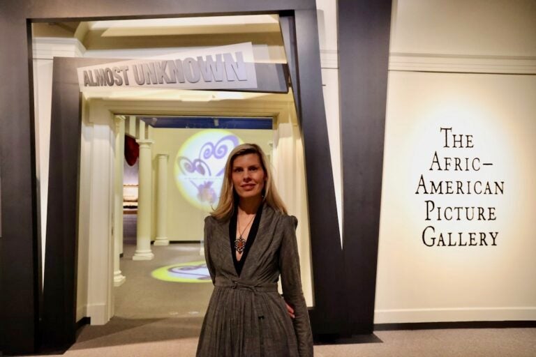 Winterthur Director of Collections Alexandra Deutsch standing in front of exhibit