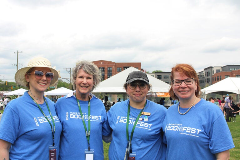bucks-county-book-festival-1 From left, Krisy Elisii, Glenda Childs, Kate Steck and Lauren Ford, organizers of the seventh annual Bucks County Book Festival, pose for a photo on Saturday, May 3, 2025, at Broad Commons Park in Doylestown. (Emily Neil/WHYY)