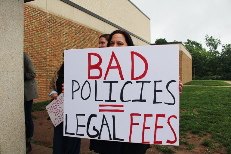 centennial-school-district-lucabaugh-1 a parent protesting he possible appointment of Abram Lucabaugh as Centennial School District's new superintendent holds a sign reading BAD POLICIES = LEGAL FEES