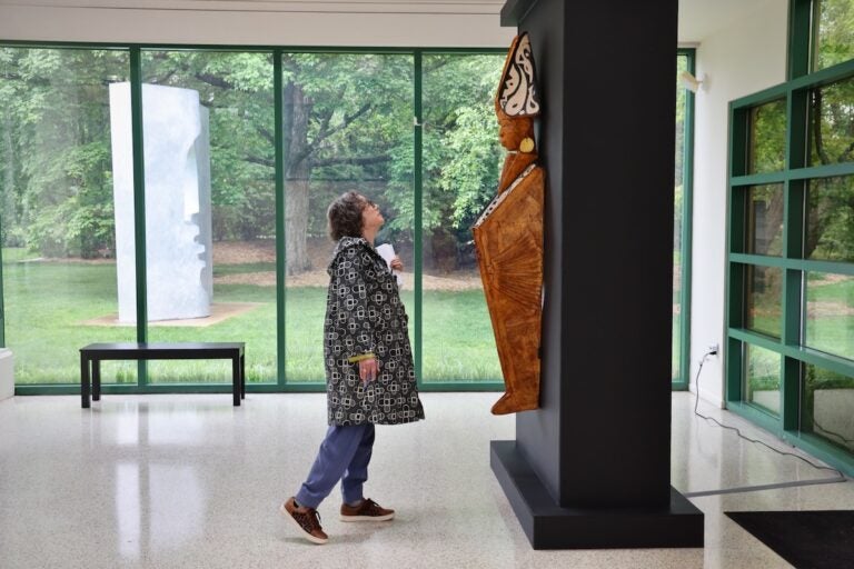 Visitor inspecting Clifford Ward sculpture