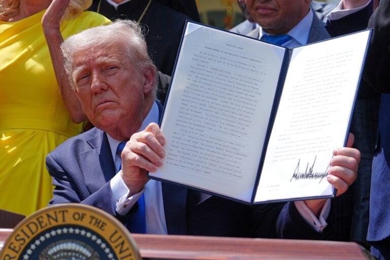 donald-trump-executive-order-2025-05-01 Donald Trump holds up a signed executive order