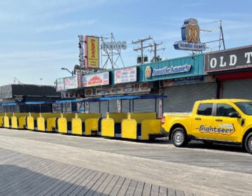A hybrid Ford Maverick truck towing the tram car on the Wildwood Boardwalk