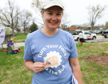 Collie Turner holding photos of her grandfather, Joseph C. Stevens,
