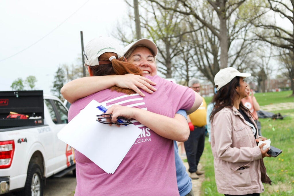 Collie Turner greets and hugs volunteers at Heroic Gardens