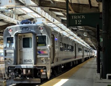 A New Jersey Transit commuter train on a rail platform in Hoboken, New Jersey