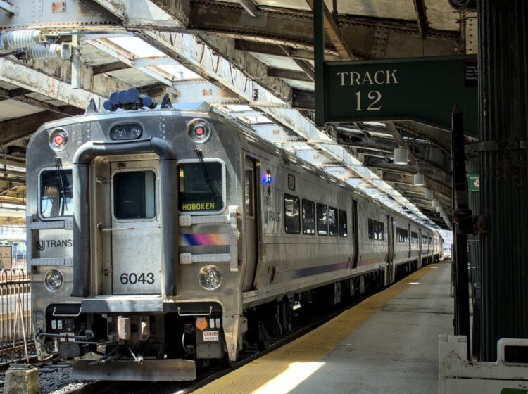 A New Jersey Transit commuter train on a rail platform in Hoboken, New Jersey