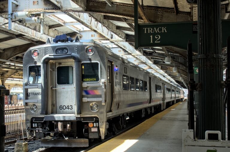 A New Jersey Transit commuter train on a rail platform in Hoboken, New Jersey