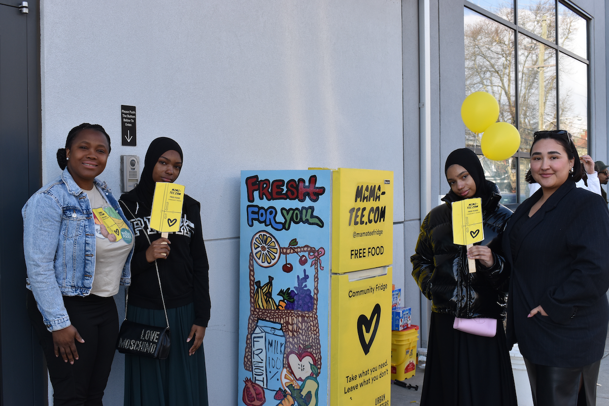 Students at Mural Arts standing with decorated fridge