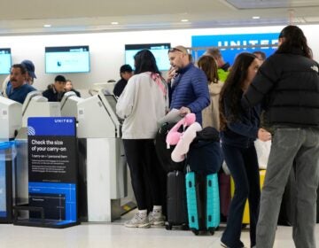 Travelers check into their flights at Newark Liberty International Airport
