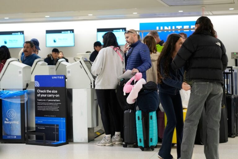 Travelers check into their flights at Newark Liberty International Airport