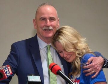 Pat Dugan hugs his wife