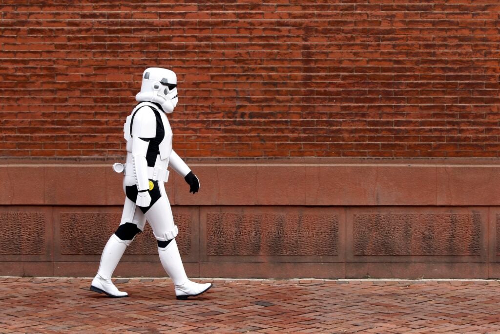 A person walking down the street dressed as a Stormtrooper