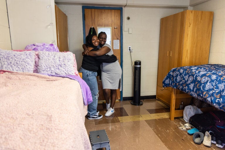 Roommates Chobe and Joy hug and smile at the HomeWorks Trenton