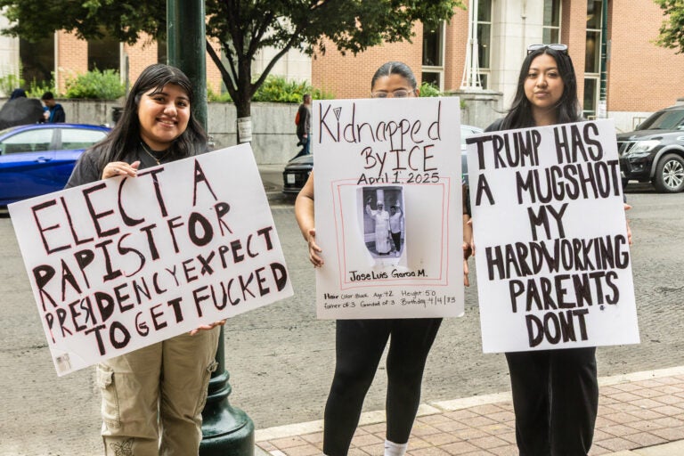 Protesters from South Philadelphia Jocelyn Flores (right), Alondra Garcis (center) and Lizveth Perez (left) joined the No Kings event on June 14, 2025. (Kimberly Paynter/WHYY)