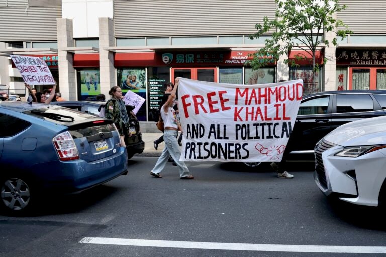 Protesters disrupt traffic on 8th Street during a protest spurred by ICE arrests.