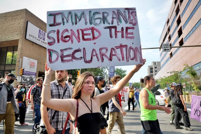 Destiny Danao of South Philadelphia carries a sign during a protest spurred by recent ICE arrests. ''It's my duty as a citizen to stand up for people who can't, who are afraid to come out.''
