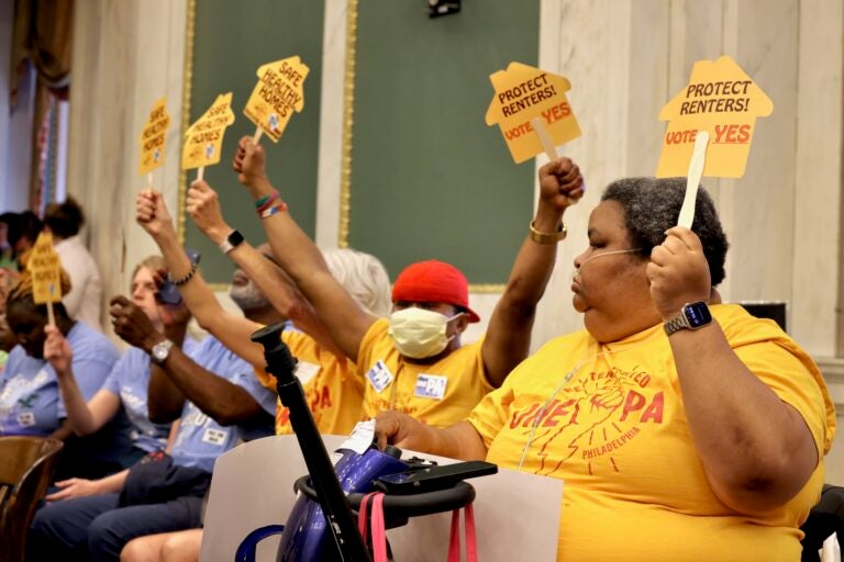 2025 06 13-e lee-philadelphia city hall-council meeting renter protection Members of OnePA Renters United Philadelphia hold signs reading SAFE HEALTHY HOMES and PROTECT RENTERS! VOTE YES