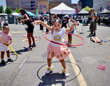 A young girl hula hooping