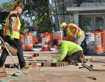 Construction workers labor in the hot sun on June 19, 2025. (Emma Lee/WHYY)