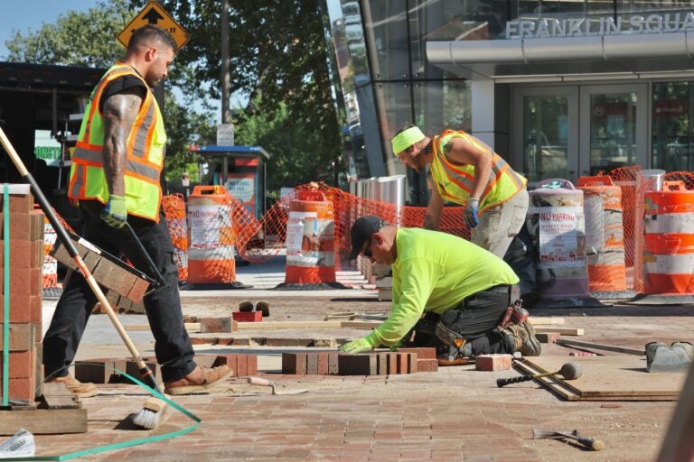 Construction workers labor in the hot sun on June 19, 2025. (Emma Lee/WHYY)