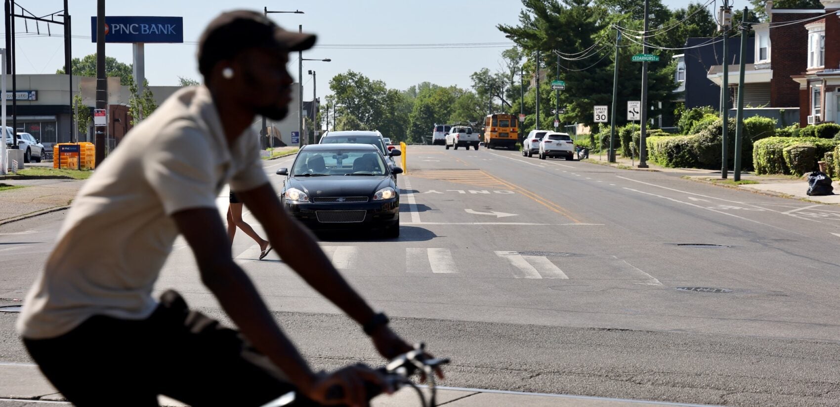 2025 06 25-e lee-philadelphia cobbs creek-dangerous intersection cyclist a cyclist crosses the intersection of Baltimore Avenue, Cobbs Creek Parkway and 58th Street